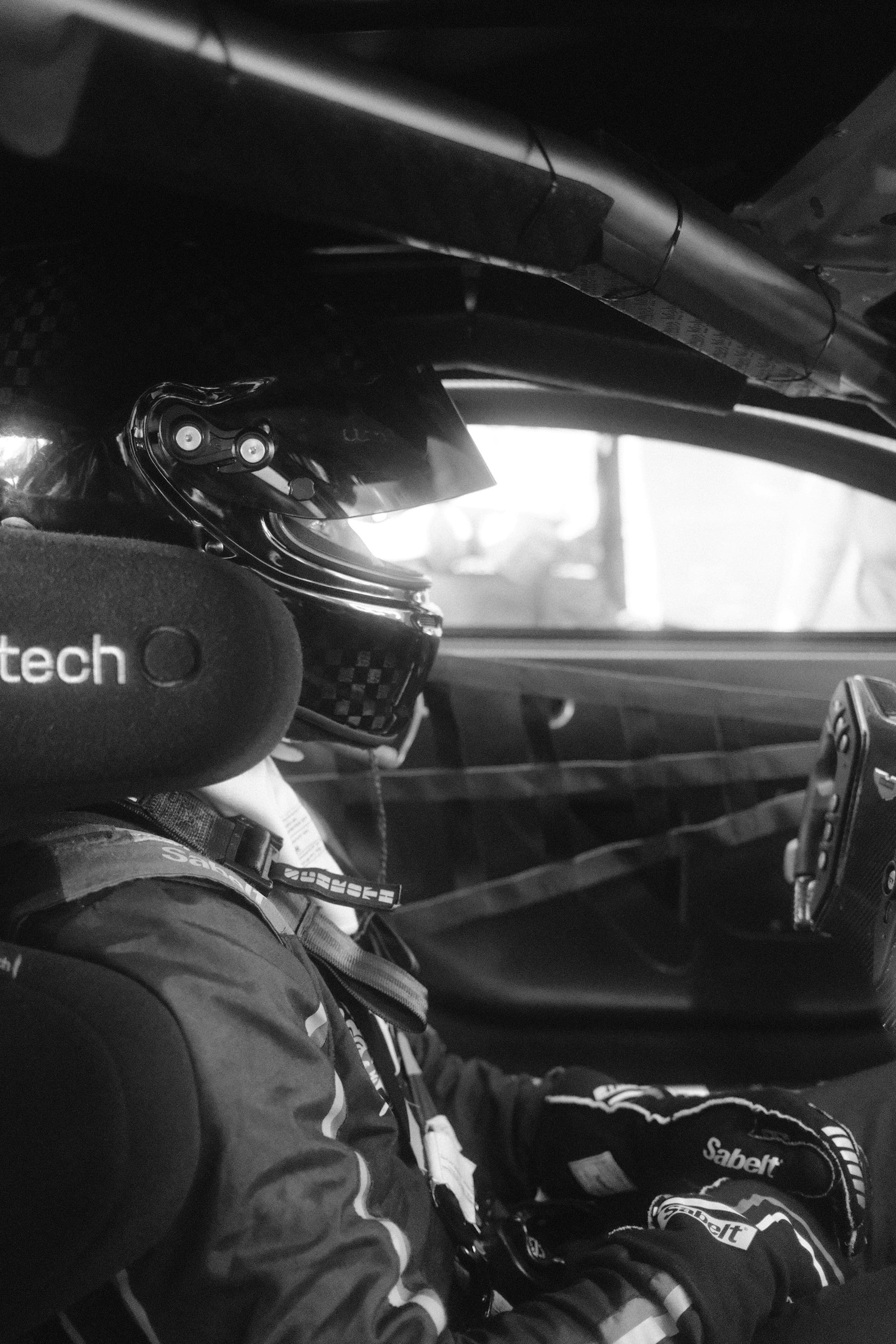 Race driver seated inside a competition car